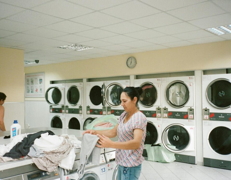 photo of woman standing inside the laundromat