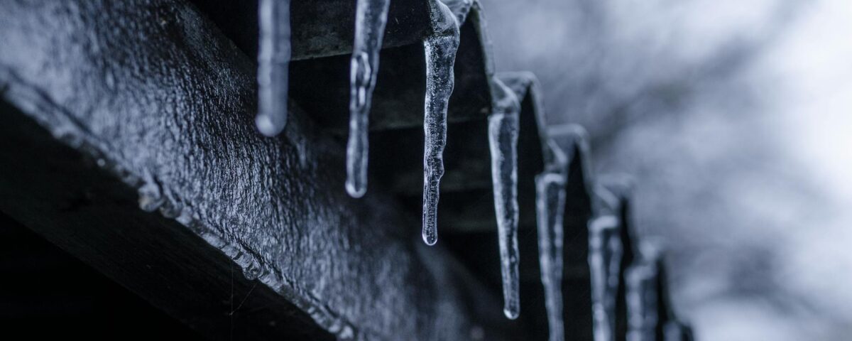close up photography of ice crystals on edges of corrugated sheets