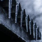 close up photography of ice crystals on edges of corrugated sheets