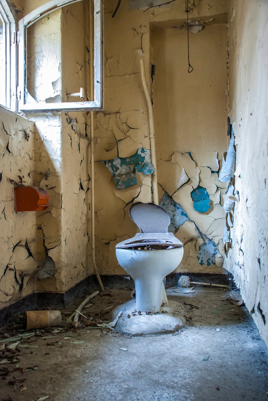 a damaged toilet inside an abandoned building